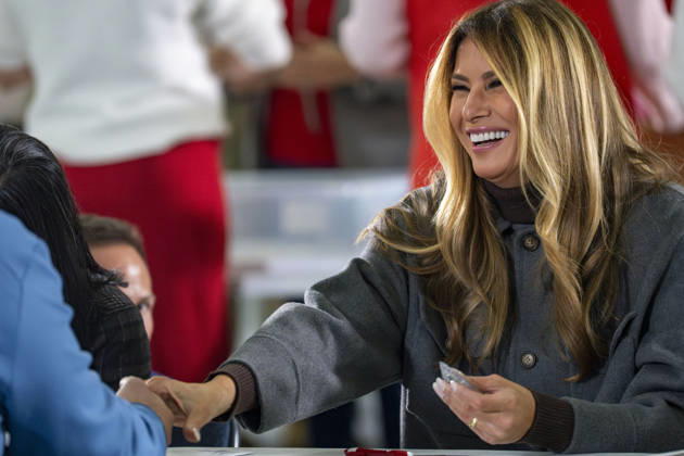 First Lady Melania Trump shakes hands with a volunteer while creating care packages for deployed Service members with Second Lady Usha Vance, the American Red Cross, U.S. Government Cabinet spouses and military spouses at Joint Base Andrews in Prince Georges County, Maryland on Monday, December 1, 2025. WAP20251201364 BONNIExCASH