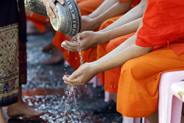 Buddhist ceremony. Worshipper washing the hands of Buddhist monks. Purification ritual. Luang Prabang. Luang Prabang. Laos. Luang Prabang Laos