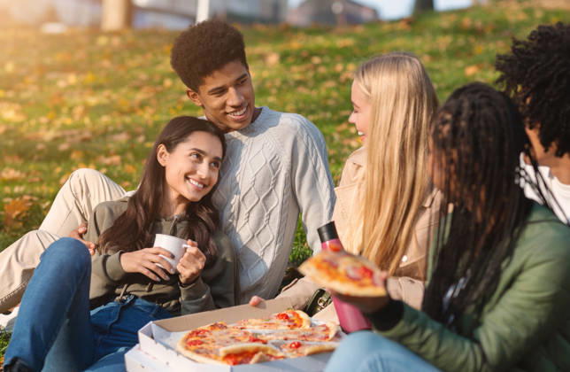 Group of multiracial friends having fun at public park Group of multiracial happy friends having fun at public park, eating pizza and talking, model released, , 61571544.jpg RECORD DATE NOT STATED