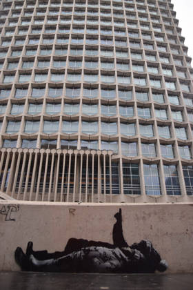 December 21, 2025, London, England, United Kingdom: A new artwork, suspected to be by elusive street artist Banksy, has appeared outside Centre Point and Tottenham Court Road Station. The artwork depicts two children lying on their backs and pointing upwards. The artwork has not yet been confirmed as a genuine Banksy. London United Kingdom - ZUMAv130 20251221_zip_v130_009 Copyright: xVukxValcicx