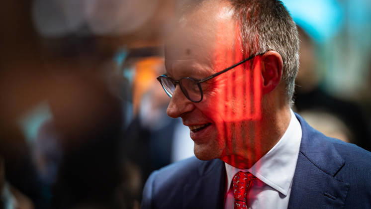 Federal Chancellor Friedrich Merz with a red light reflection on his face during the election campaign event Baden Württemberg in the election year 2026, Federal Chancellor and CDU top candidate visiting Pfenning Logistics in Heddesheim, Heddesheim Baden Württemberg Germany Company premises Pfenning Logistic