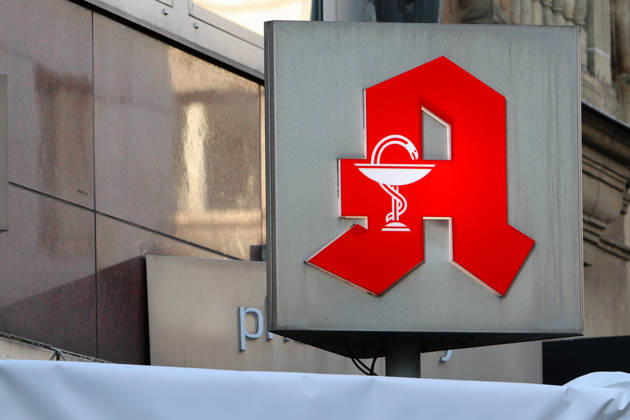 Pharmaceuticals from the pharmacy A pharmacy logo can be found on the façade of a building