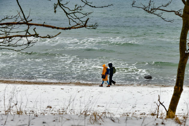 Baltic Sea in winter People walking on the wintry Baltic Sea beach at the Wilhelmshöhe near Warnemünde Warnemünde Mecklenburg Western Pomerania Germany JK15336