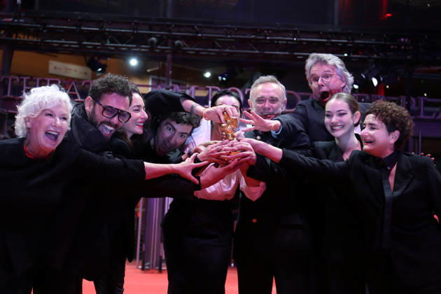 February 21, 2026, Berlin, Germany: ILKER CATAK, with cast and crew pose with the Golden Bear for Best Film for Gelbe Briefe (Yellow Letters) after the closing ceremony of the 76th Berlin International Film Festival (Berlinale), Europe s first major film festival of the year, in Berlin. The festival runs from February 12 to 22. Berlin Germany  - ZUMAf146 20260221_zip_f146_015 Copyright: xRouzbehxFouladix