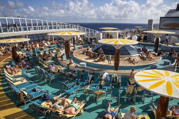 Relaxing on deck on the high seas Passengers on an AIDAblu cruise ship enjoy the voyage through the Caribbean St John s Antigua and Barbuda on the sun deck