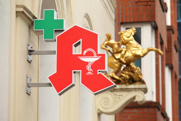 A pharmacy A hangs on the facade of a pharmacy in Lange Reihe Behind it, a gold sculpture has been attached to the facade St Georg Hamburg