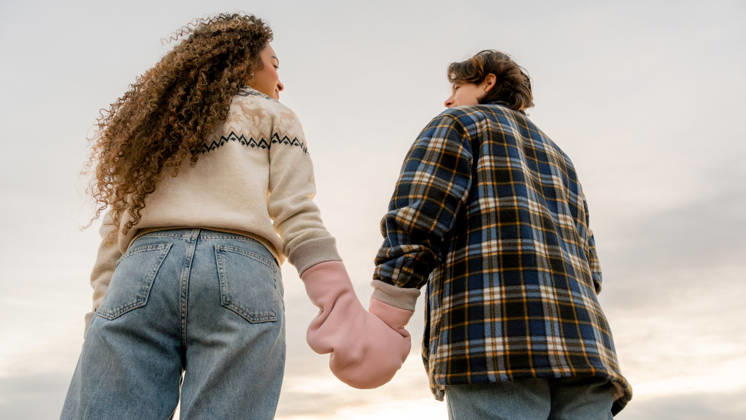 Young couple holding hands as a symbol of pride A young lesbian couple holding hands, symbolizing their love and pride. Captured from behind against a serene sky, showcasing unity and LGBT representation in a beautiful moment. Model Released SilviaRedondo_ID33866_1192396_031 Copyright: xSilviaxRedondox RECORD DATE NOT STATED