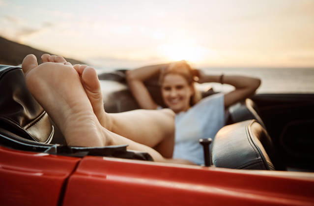 Road trip, rest or feet in car with beach sunset, outdoor destination or relaxing on tourist vacation. Travel, chill or woman at ocean with vehicle, weekend break or summer evening in Australia model released property released Copyright: xx