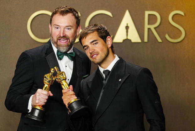 Sam A. Davis and Jack Piatt celebrate in the press photo room after winning the best Live Action Short Film Oscar for The Singers during the 98th annual Academy Awards in the Hollywood section of Los Angeles on Sunday, March 15, 2026. Conan O Brien is hosting the Oscars for the second consecutive year.  LAP202603152311 BONNIExCASH