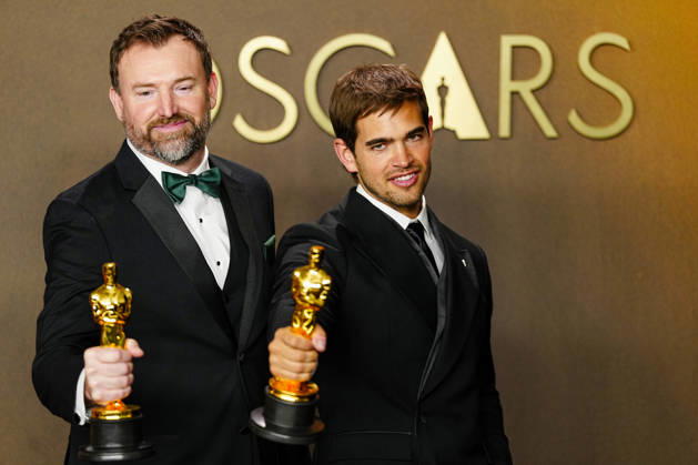 Sam A. Davis and Jack Piatt celebrate in the press photo room after winning the best Live Action Short Film Oscar for The Singers during the 98th annual Academy Awards in the Hollywood section of Los Angeles on Sunday, March 15, 2026. Conan O Brien is hosting the Oscars for the second consecutive year.  LAP202603152312 BONNIExCASH