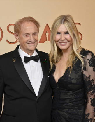 Mike Medavoy and Irena Medavoy arrive on the red carpet for the 98th annual Academy Awards in the Hollywood section of Los Angeles on Sunday, March 15, 2026. Conan O Brien will host the Oscars for the second consecutive year.  LAP202603153242 JIMxRUYMEN