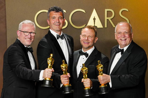 Richard Baneham, Joe Letteri, Daniel Barrertt, and Eric Saindon celebrate in the press photo room after winning the Best Visual Effects Oscar for Avatar: Fire and Ash during the 98th annual Academy Awards in the Hollywood section of Los Angeles on Sunday, March 15, 2026.  LAP20260315375 BONNIExCASH