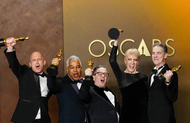 Gareth John, Al Nelson, Gwendolyn Yates Whittle, Gary A. Rizzo, and Juan Peralta celebrate in the press photo room after winning the Best Sound Oscar for F1 during the 98th annual Academy Awards in the Hollywood section of Los Angeles on Sunday, March 15, 2026.  LAP20260315384 BONNIExCASH