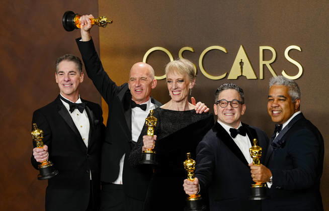 Gareth John, Al Nelson, Gwendolyn Yates Whittle, Gary A. Rizzo, and Juan Peralta celebrate in the press photo room after winning the Best Sound Oscar for F1 during the 98th annual Academy Awards in the Hollywood section of Los Angeles on Sunday, March 15, 2026.  LAP20260315382 BONNIExCASH