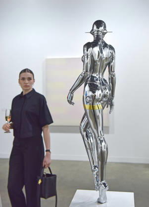 (260326) -- HONG KONG, March 26, 2026 -- A visitor views an exhibit at the preview of Art Basel Hong Kong 2026 at the Hong Kong Convention and Exhibition Center in south China s Hong Kong, March 25, 2026. Art Basel Hong Kong 2026 held its preview here on Wednesday, bringing together 240 galleries from 41 countries and regions. Featuring six themed sectors and programs, the fair will open to the public from Friday to Sunday. ) CHINA-HONG KONG-ART BASEL-PREVIEW (CN) ChenxDuo 