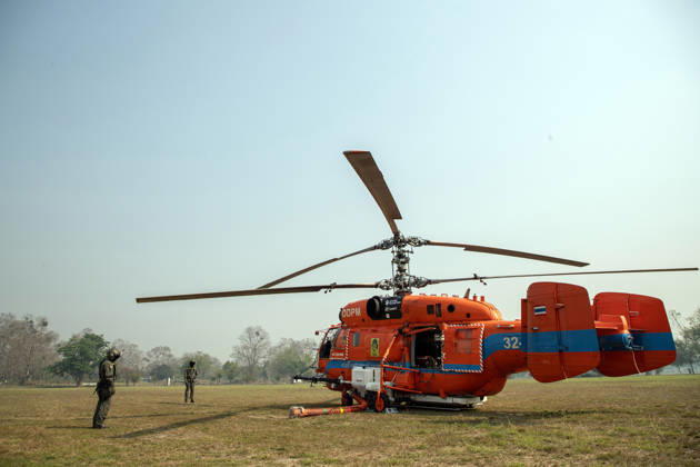 March 27, 2026, Chiang Mai, Thailand: A KA-32 helicopter from the Department of Disaster Prevention and Mitigation is prepared for aerial firefighting operations in Chiang Mai, northern Thailand, as crew members carry out checks and equipment setup while authorities respond to ongoing wildfires and rising PM2.5 air pollution. Chiang Mai Thailand - ZUMAs197 20260327_aaa_s197_311 Copyright: xPongmanatxTasirix