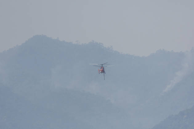 March 27, 2026, Chiang Mai, Thailand: A KA-32 helicopter from the Department of Disaster Prevention and Mitigation conducts aerial firefighting operations over mountainous forest areas in Chiang Mai, northern Thailand, carrying a water bucket while flying through smoke-filled valleys as authorities battle ongoing wildfires and severe PM2.5 air pollution. Chiang Mai Thailand - ZUMAs197 20260327_aaa_s197_358 Copyright: xPongmanatxTasirix