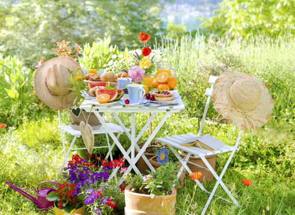 Breakfast for two, served at a Table at bunt blooming Garden on Lake with Sun hats and Hearts, Composing Breakfast for two, served ON a Table in a Colorful Garden blooming With coneflowers and hearts, Composing BLWS745584 Copyright: xblickwinkel C.xLesjakx