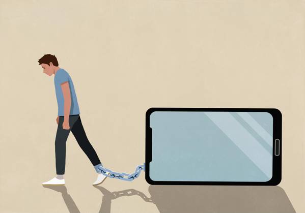 Man dragging large smart phone chained to his ankle on beige background  Copyright: MaltexMueller fStopImages2097029
