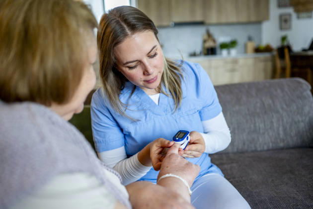 Diabetologist nurse testing blood sample on blood sugar meter. Diabetologist nurse testing blood sample on blood sugar meter, elderly woman diagnosed with diabetes. model released