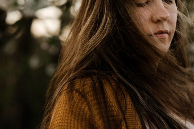 Close up of a woman with long brown hair with her eyes closed outdoors Calgary, Alberta, Canada CR_AMST26041009-1892963-01 ,model released, Symbolfoto ,property released