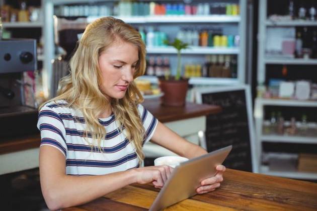 Woman sitting in a cafe using digital tablet Thoughtful woman sitting in a cafe using digital tablet, model released, , property released, Cape Town, South Africa, 30.05.2016, 797484.jpg, table, cafe, coffee shop, cafeteria, restaurant, hotel, casual clothing, sitting, holding, serious, thoughtful, web, internet, touching, reading, scrolling, digital tablet, tablet computer, tablet pc, touchscreen, wireless technology, communication, connection, lifestyle, leisure, pretty, attractive Indoors