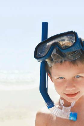 Boy Wearing Snorkeling Goggles On Beach - Closeup portrait of young boy wearing snorkeling goggles on beach model released Symbolfoto Copyright: xmoodboardx Panthermedia75344126.jpg