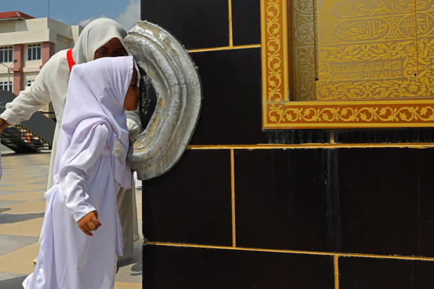April 27, 2026, Banda Aceh, Aceh, Indonesia: Kindergarteners children Kissing the Hajar al-Aswad at the miniature Kaaba companied by teacher during Hajj manasik education at the Aceh Hajj Embarkation Dormitory in Banda Aceh City, Aceh province, Indonesia on Monday, April 27, 2026. The activity which was attended by thousands of kindergarten students, aims to introduce the procedures for Hajj to children from an early age. Banda Aceh Indonesia - ZUMAs340 20260427_zip_s340_014 Copyright: xKhairuxSyukrillahx