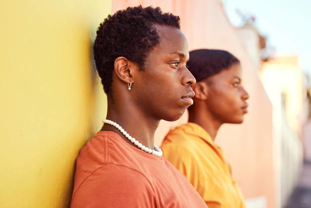 Urban fashion, African people and couple of friends relax with designer brand clothes, casual style and luxury apparel. Gen z aesthetic, color and profile of black woman and man on orange yellow wall. (License=RF) ,model released, Symbolfoto  Copyright: xZoonar.com YurixArcursxpeopleimages.comx 19615238 ,model released, Symbolfoto ,property released