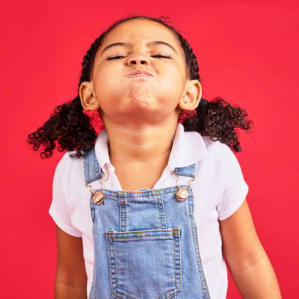 Attitude, childhood and face of girl on red background in studio with angry, upset and frustrated reaction. Emoji, comic and young kid with air in cheeks, tantrum behaviour and mad facial expression. (License=RF) ,model released, Symbolfoto  Copyright: xZoonar.com YurixArcursxpeopleimages.comx 19733373 ,model released, Symbolfoto ,property released