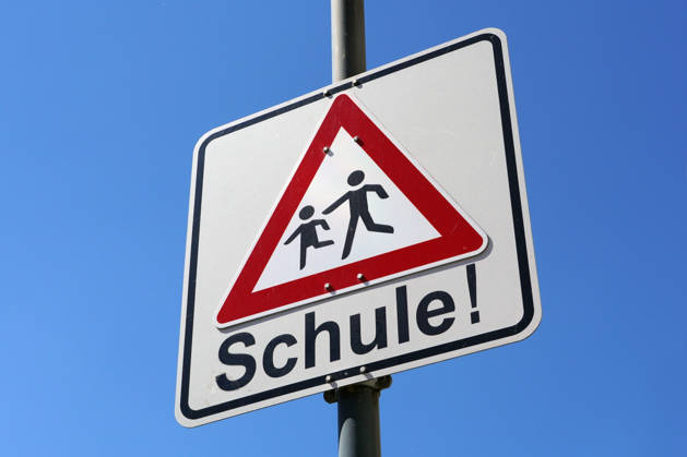Caution Children at Road traffic, Traffic sign before a School, Risk of accident, slow drive 1131609419