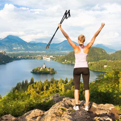 Made it! Young spoty active lady with hiking sticks and hands rised admiring beautiful nature around Bled Lake in Julian Alps, Slovenia. model released Symbolfoto Copyright: xkastox Panthermedia71421136.jpg