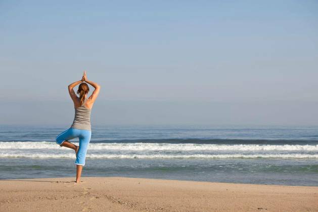 Beautiful young woman with arms open, relaxing on the beach model released Symbolfoto Copyright: xIkox Panthermedia67186144.jpg