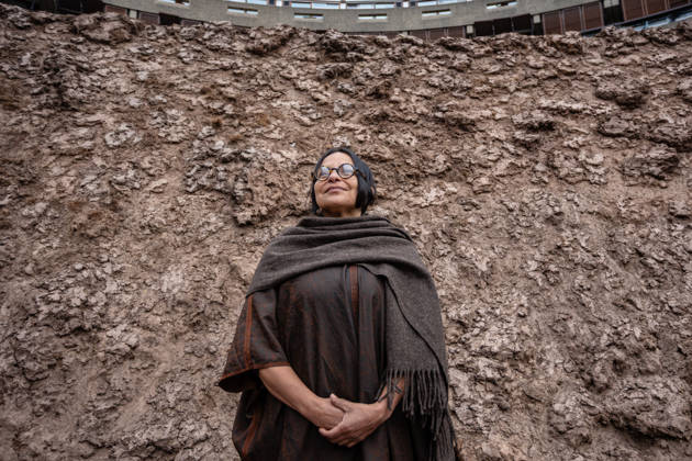 Delcy Morelos: origo at the Barbican Sculpture Court, London, UK 14 May 2026 Colombian artist Delcy Morelos poses with her sculpture origo at the Barbican Sculpture Court, London, UK, on 14 May 2026. The giant earthen sculpture spans roughly 24 x 18 metres and is hand-built with several tonnes of soil and aromatic spices including cinnamon and coffee, initially inspired by the architecture of the Yanomami people of the Amazon, on view from 15 May until 31 July 2026., Credit:Pete Speller Avalon  Copyright: xPetexSpellerx xAvalonx 1098917549