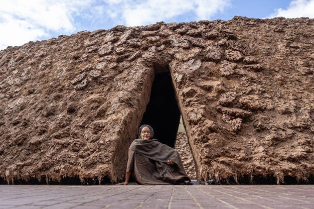 Delcy Morelos: origo at the Barbican Sculpture Court, London, UK 14 May 2026 Colombian artist Delcy Morelos poses with her sculpture origo at the Barbican Sculpture Court, London, UK, on 14 May 2026. The giant earthen sculpture spans roughly 24 x 18 metres and is hand-built with several tonnes of soil and aromatic spices including cinnamon and coffee, initially inspired by the architecture of the Yanomami people of the Amazon, on view from 15 May until 31 July 2026., Credit:Pete Speller Avalon  Copyright: xPetexSpellerx xAvalonx 1098917931