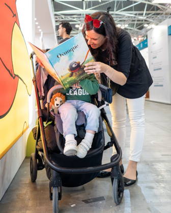 May 15, 2026, Turin, To, Italy: Some moments from the second day of the International Book Fair. Pictured is a mother reading a book to a little girl. Turin, May 15, 2026 Turin Italy - ZUMAa289 20260515_zia_a289_015 Copyright: xSelenexDanielex xAgfx