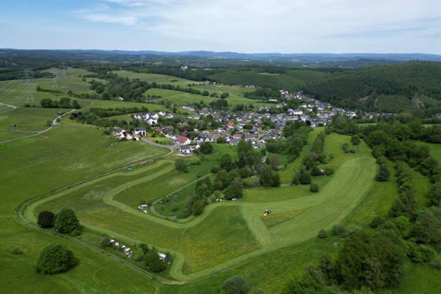 Aerial view spring spring in Siegerland A lush green meadow is mowed in the foreground by a tractor with a mower mowed in the background the place Siegen Oberschelden spring spring in Siegerland on 23 05 2026 in Siegen Germany