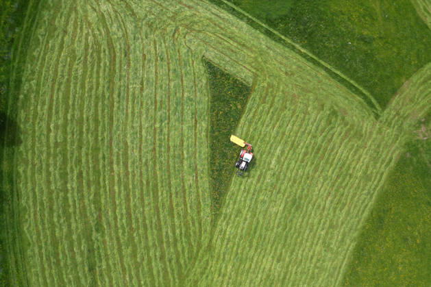 Aerial view spring spring in Siegerland A lush green meadow is mowed by a tractor with a mower mower near Siegen Oberschelden spring spring in Siegerland on 23 05 2026 in Siegen Germany