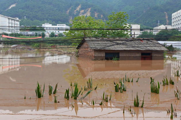 CHONGQING, CHINA - MAY 24: Houses and crops are submerged after extreme rainfalls trigger flash floods and geological disasters on May 24, 2026 in Yongchuan District, Chongqing City, China. Devastating rainstorms struck parts of Southwest China s Chongqing over the weekend, resulting in multiple casualties and missing people in the municipality s Yongchuan and Beibei districts. Rescue efforts are ongoing. As of 2:30 pm on May 24, local authorities reported three deaths and 17 people missing in Yongchuan, with another two people missing in Beibei.  Copyright: xChinaxNewsxServicex 111643812941