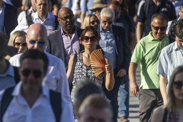 May 26, 2026, London, London, UK: London, UK. A commuter crossing London Bridge cools down with a folding fan. According to the weather office, it will be another fine and dry day. High of 35Ã‚Â°C. London UK  - ZUMAl94_ 20260526_zaf_l94_012 Copyright: xMarcinxNowakx