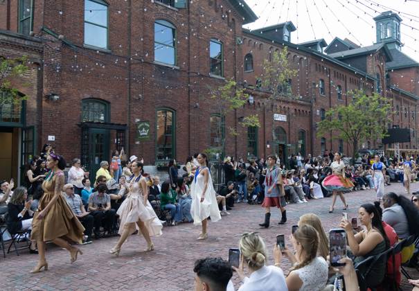 (260527) -- TORONTO, May 27, 2026 -- Models present creations on a pedestrian street during the Fashion Art Toronto s Fashion Week Spring Summer 2026 in Toronto, Canada, on May 26, 2026. (Photo by Xinhua) CANADA-TORONTO-FASHION WEEK ZouxZheng 