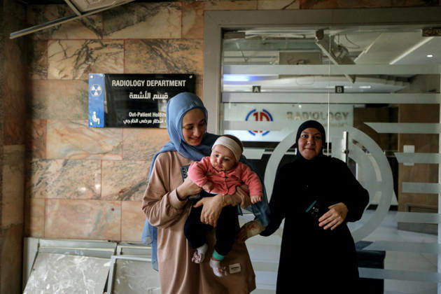 June 2, 2026, Tyre, Tyre, Lebanon: Battoul carries her 4 month old daughter Fatima at the entrance of Radiology department at Jabal Amel Hospital that was partially destroyed in Israeli air strikes in the southern Lebanese port city of Tyre. Battoul, who is married to an employee in the hospital, fled her apartment to live with her husband and daughter inside the sanatorium. Clashes have continued in southern Lebanon despite Israel and Hezbollah accepting a US plan for a partial ceasefire. President Donald Trump said he had spoken to both sides and they agreed that all shooting will stop , after Iran warned Israeli military actions in Lebanon were a threat to the US-Iran ceasefire. Tyre Lebanon - ZUMAn313 20260602_zip_n313_013 Copyright: xMarwanxNaamanix