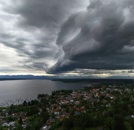 An early summer day in Tutzing, Starnberg district Here the view over the village and Lake Starnberg with the Alps on the horizon, where a thunderstorm is just coming up, a wall of clouds, thunderstorm roll, cloud roll, thunderstorm front, thunderstorm roll, thunderstorm front, dark clouds, weather picture