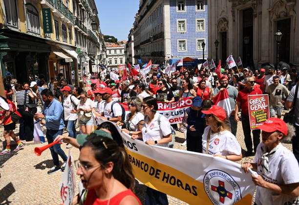 Nationwide Strike For Workers Lisbon LISBON, PORTUGAL - JUNE 03: Protesters hold a banner and wave red trade union flags as they line the streets during a national mobilization in Lisbon, Portugal on June 03, 2026. The demonstration, organized under the National Fight Day motto, demands increased wages, guaranteed labor rights, and measures against the rising cost of living, while advocating for the right to health and housing. Zed Jameson Anadolu Lisbon Portugal. Editorial use only. Please get in touch for any other usage.  Copyright: x2026xAnadoluxZedxJamesonx