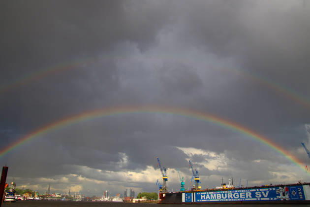 After a thunderstorm, two rainbows appear over the port of Hamburg