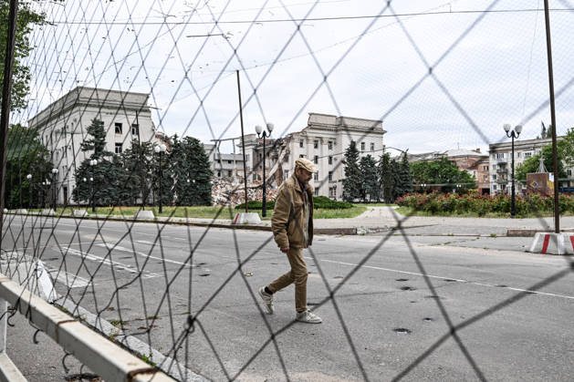 RECORD DATE NOT STATED A man walks along a road covered with anti-drone netting installed to protect against Russian FPV drones in the red zone of the frontline city of Kherson, the area considered the most dangerous due to constant Russian attacks, Kherson, Ukraine, on June 3, 2026. The Russian army attacks the city daily with FPV drones and other unmanned aerial vehicles, deliberately terrorizing civilians. Russian forces conduct hunts for local residents, tracking them with FPV drones and dropping explosives. Police officers, medics, public transport, and urban infrastructure are also targeted. Based on the intensity of attacks, Kherson is informally divided into yellow and red zones, with the red zone subjected to continuous shelling and drone strik Copyright: xDmytroxSmolienkox