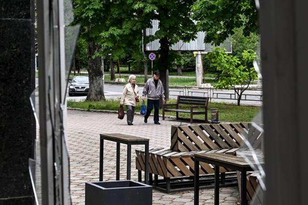 RECORD DATE NOT STATED Lone pedestrians are seen through a shattered storefront window in the red zone of the frontline city of Kherson, the area considered the most dangerous due to constant Russian attacks, Kherson, Ukraine, on June 3, 2026. The Russian army attacks the city daily with FPV drones and other unmanned aerial vehicles, deliberately terrorizing civilians. Russian forces conduct hunts for local residents, tracking them with FPV drones and dropping explosives. Police officers, medics, public transport, and urban infrastructure are also targeted. Based on the intensity of attacks, Kherson is informally divided into yellow and red zones, with the red zone subjected to continuous shelling and drone strikes. Anti-drone netting has been installed Copyright: xDmytroxSmolienkox