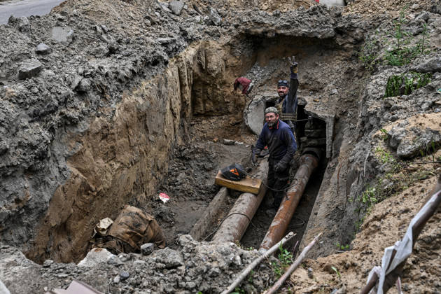 RECORD DATE NOT STATED Municipal workers repair utility pipelines in the red zone of the frontline city of Kherson, the area considered the most dangerous due to constant Russian attacks, Kherson, Ukraine, on June 3, 2026. The Russian army attacks the city daily with FPV drones and other unmanned aerial vehicles, deliberately terrorizing civilians. Russian forces conduct hunts for local residents, tracking them with FPV drones and dropping explosives. Police officers, medics, public transport, and urban infrastructure are also targeted. Based on the intensity of attacks, Kherson is informally divided into yellow and red zones, with the red zone subjected to continuous shelling and drone strikes. Anti-drone netting has been installed above roads to help Copyright: xDmytroxSmolienkox