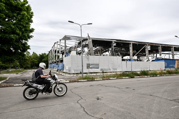 RECORD DATE NOT STATED A motorcyclist rides past the Favoryt Arena ice sports palace, destroyed in Russian guided aerial bomb (KAB) strikes, in the frontline city of Kherson, Ukraine, on June 3, 2026. The Russian army attacks the city daily with FPV drones and other unmanned aerial vehicles, deliberately terrorizing civilians. Russian forces conduct hunts for local residents, tracking them with FPV drones and dropping explosives. Police officers, medics, public transport, and urban infrastructure are also targeted (Photo by Dmytro Smolienko Ukrinform) Life under shelling in frontline Kherson Copyright: xDmytroxSmolienkox