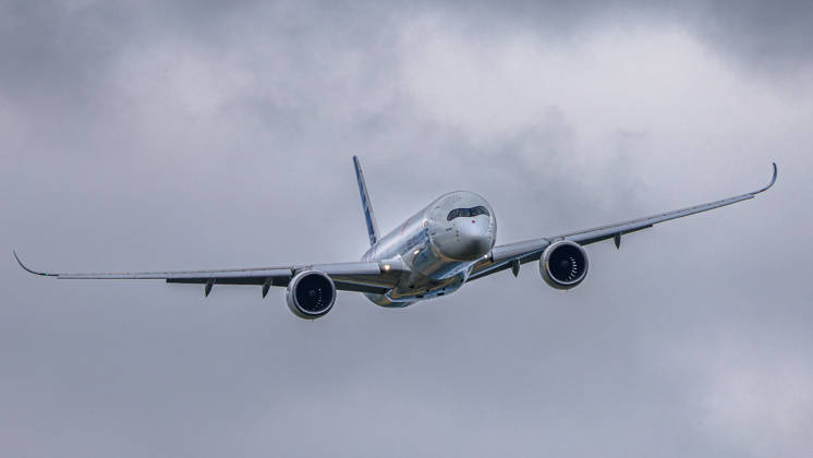 Trade visitor day at ILA Berlin 2026, Berlin, 12 06 2026 An Airbus A350 1000 in the Airbus house livery can be seen climbing against a cloudy sky The aircraft wears the characteristic carbon finish of the manufacturer Schöneberg Berlin ExpoCenter Airport Brandenburg Germany 20260612-1V9A1744-M4000